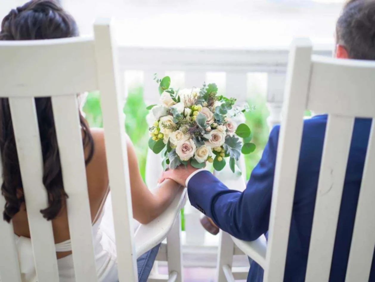 Pelican Beach destination wedding resort — bride and groom holding hands